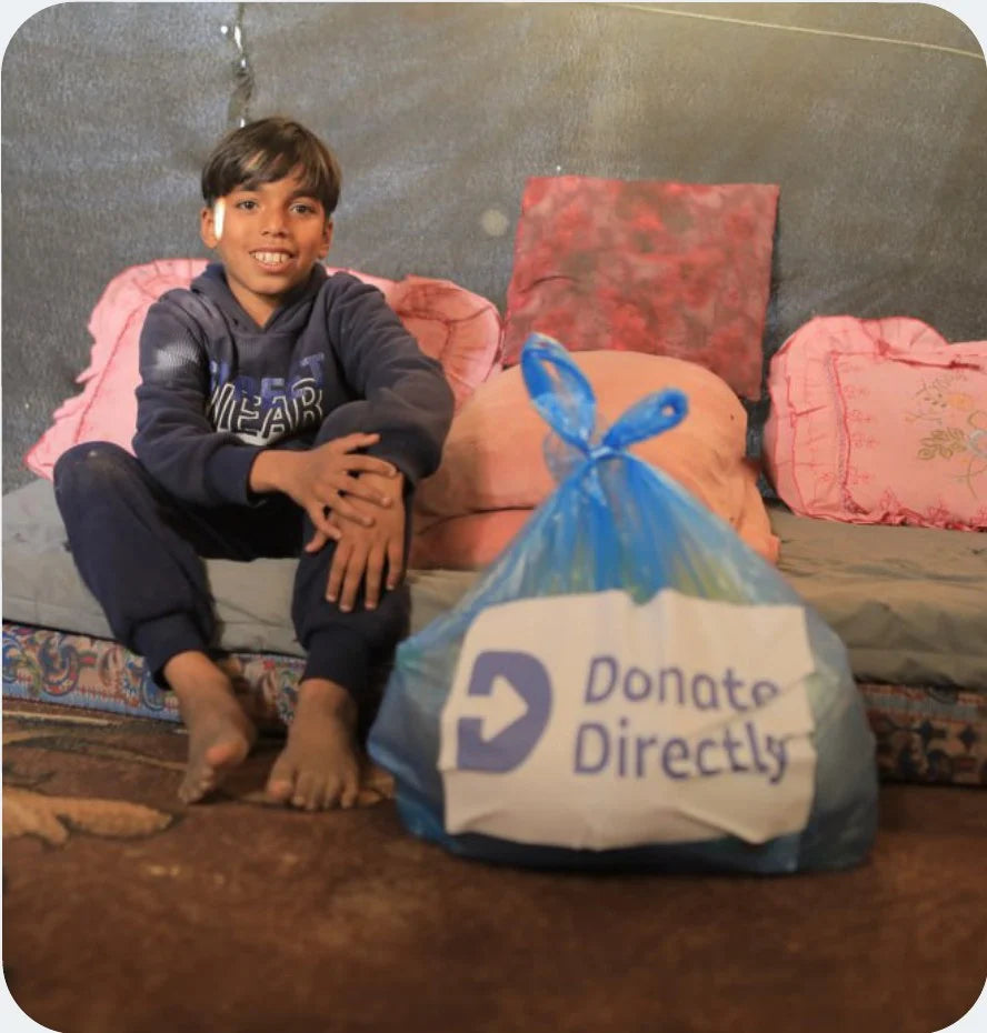Boy with Donate Directly aid package