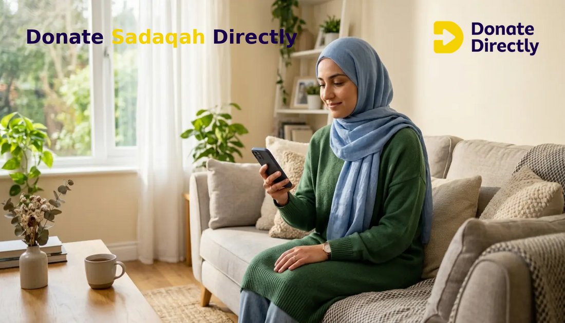 British Muslim woman donating Sadaqah on her phone in a bright UK living room