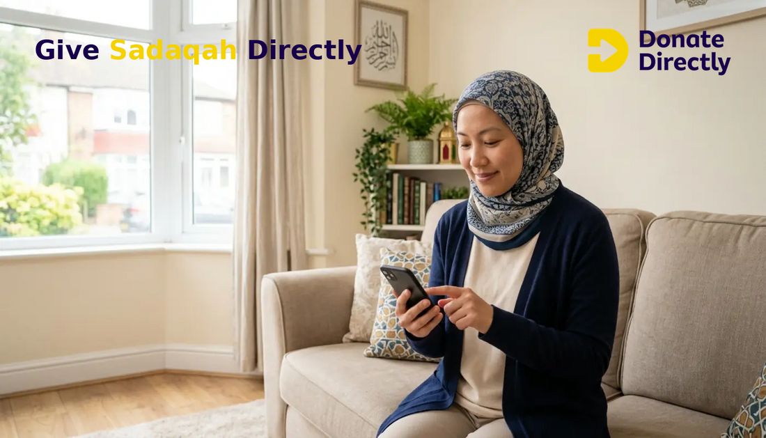 Muslim woman in a UK home donating sadaqah on her phone with a calm, hopeful expression