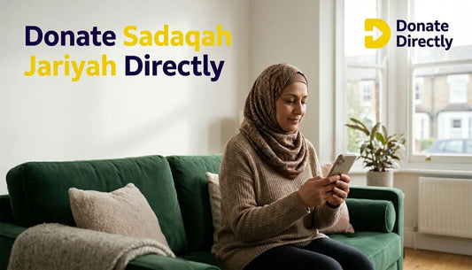 UK Muslim donor giving Sadaqah Jariyah on a phone in a warm home setting