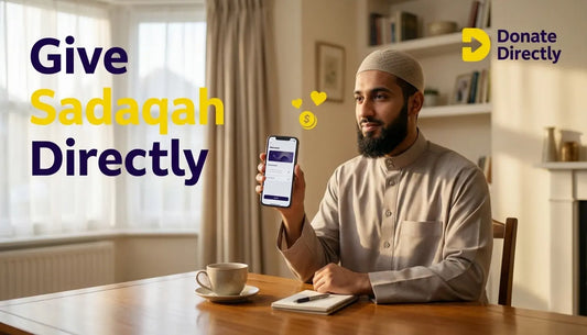 UK Muslim donor giving Sadaqah on phone in a warm home setting