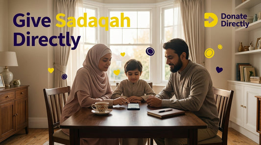 UK Muslim giving sadaqah on phone at home with calm, warm setting